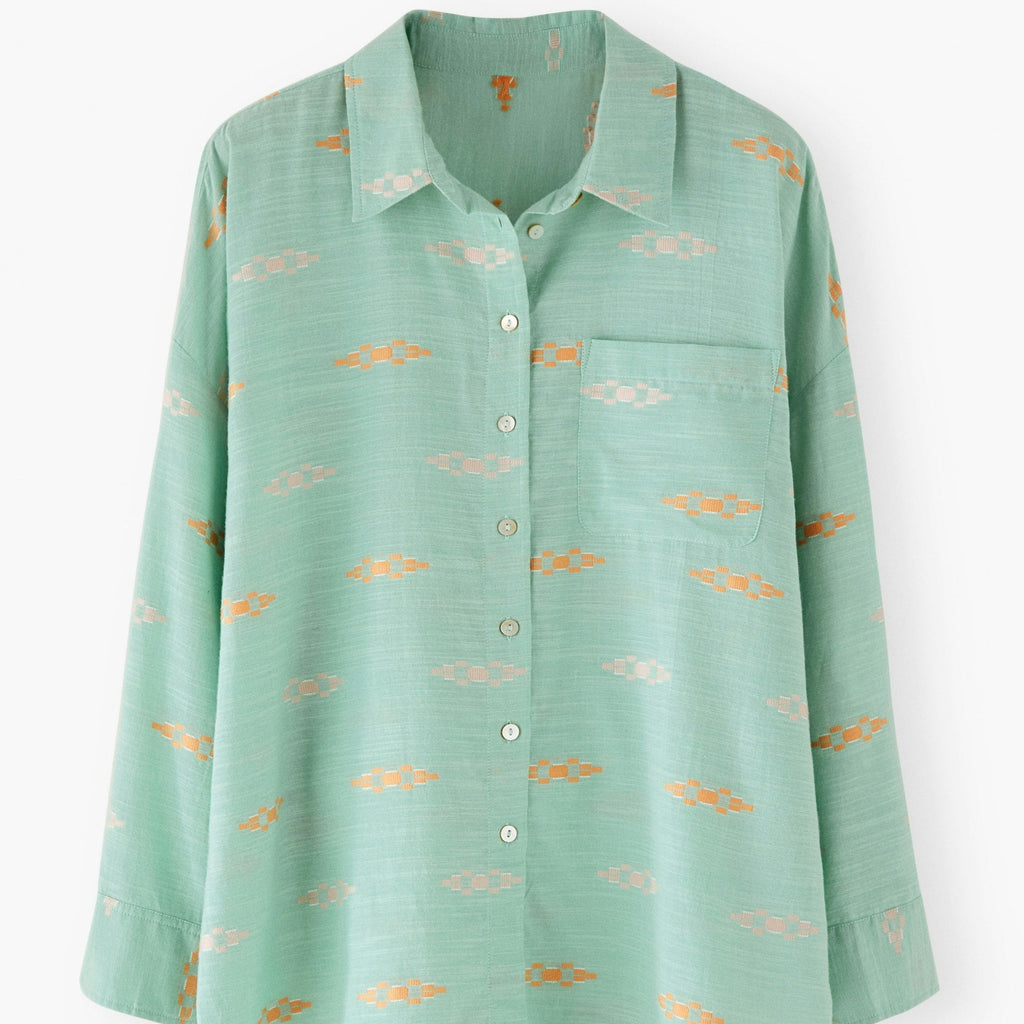 Green shirt with small patterns on a white background