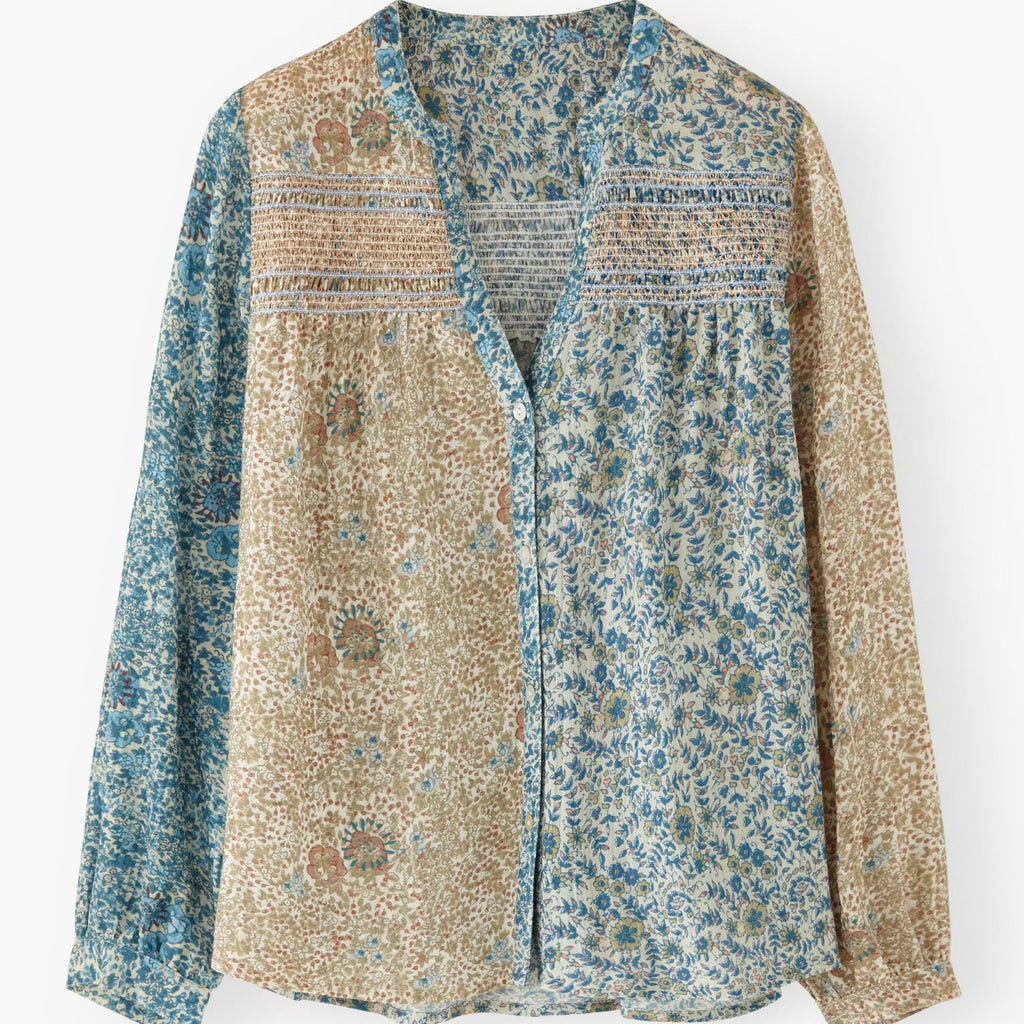 Floral patterned shirt with a mix of blue and beige colors on a white background