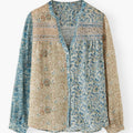 Floral patterned shirt with a mix of blue and beige colors on a white background