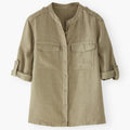 Khaki shirt with rolled-up sleeves on a white background